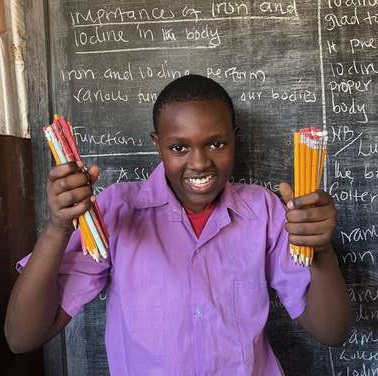 Ubuntu Africa, donated educational items, Kenyan student with pencils